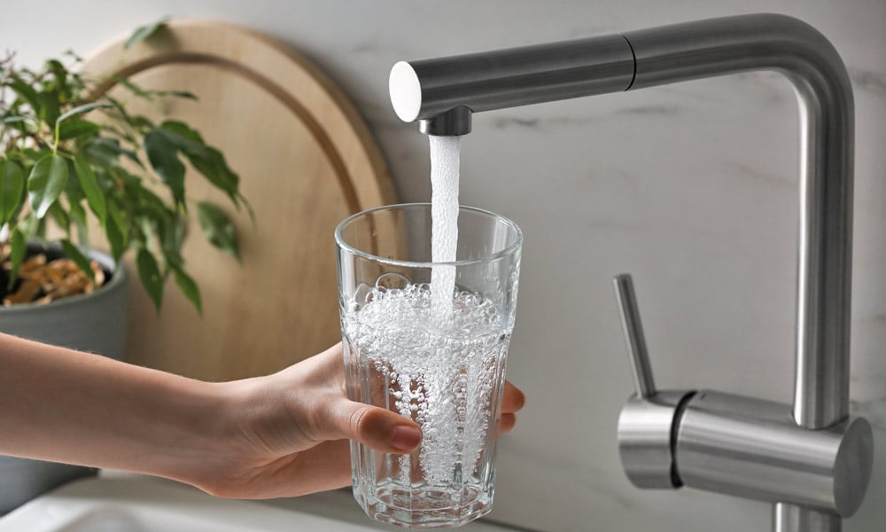 Well Pump Home Warranty Coverage | Hand Holds Glass Under Faucet