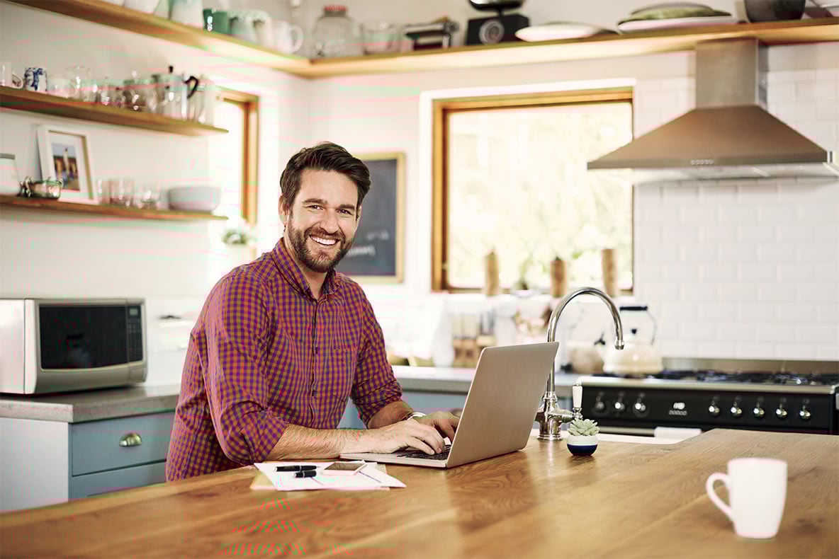 Man on laptop in nice kitchen
