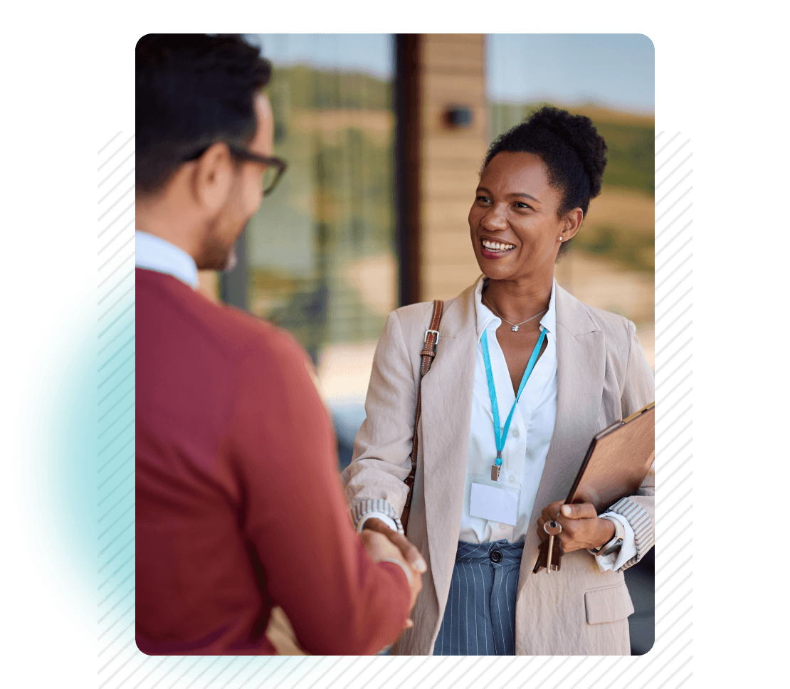 Smiling woman shaking hands with man in red sweater