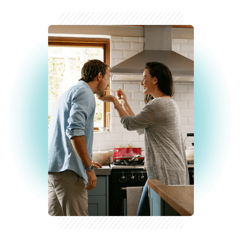 Couple trying out their food in the kitchen