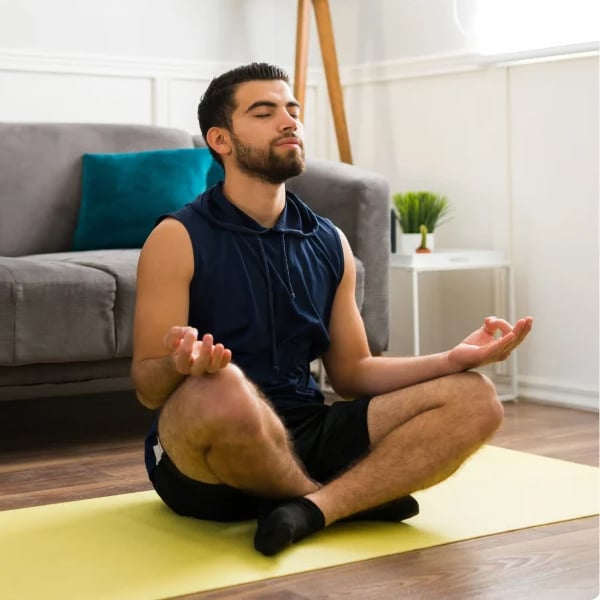 Man doing yoga on a yellow mat