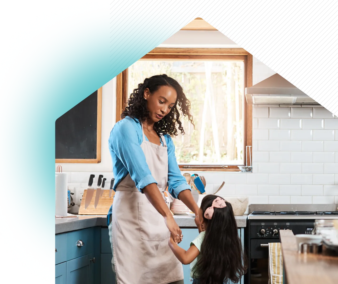 Mother and daughter dancing in kitchen