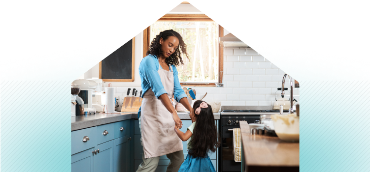 Mother and daughter dancing in kitchen