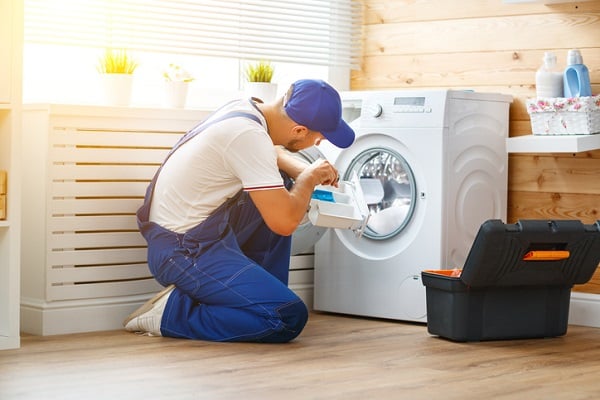 contractor fixing washing machine