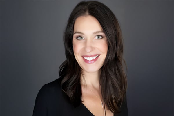 Headshot of Jeanine LaMay Kay. Woman smiling with long dark hair,