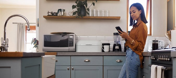 Woman on Phone in Kitchen