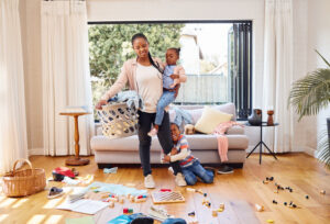 Shot of a little boy throwing a tantrum while his mother holds him at home