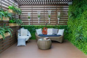 outdoor room with plants, furniture, and a red guitar