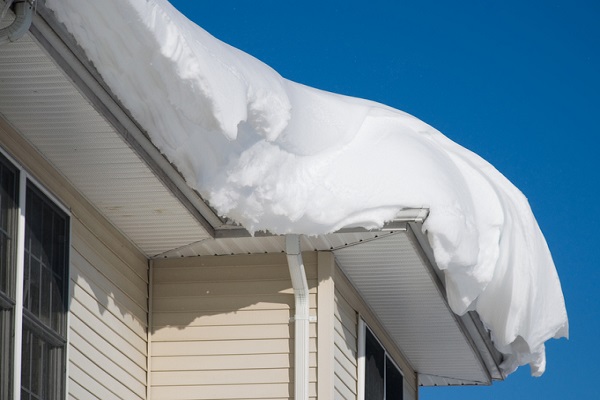 Thick pile of snow on the rooftop of a house