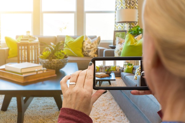 A person taking a picture of a house interior for a listing