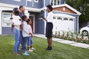 A real estate agent discussing a home with a family of five.