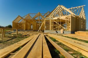 New home being built with wood plank, trusses. and assorted supplies