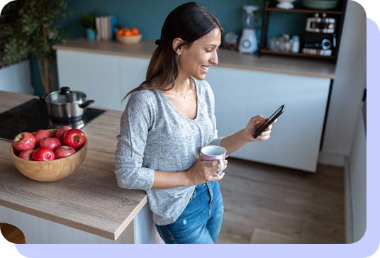 Woman drinking coffee and using cellphone