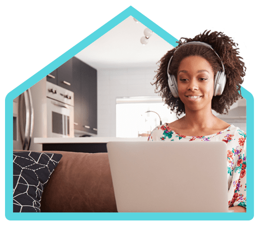 Woman working on laptop listening to music