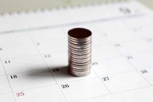 stack of coins on a calendar
