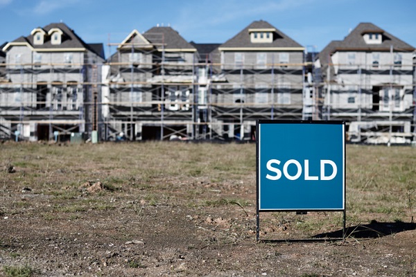 SOLD Sign Posted in Front of New Construction Houses in a Up-and-Coming NeighborhoodNow Selling Sign Posted in Front of a New Construction Home in a Up-and-Coming NeighborhoodNow Selling Sign Posted in Front of a New Construction Home in a Up-and-Coming Neighborhood