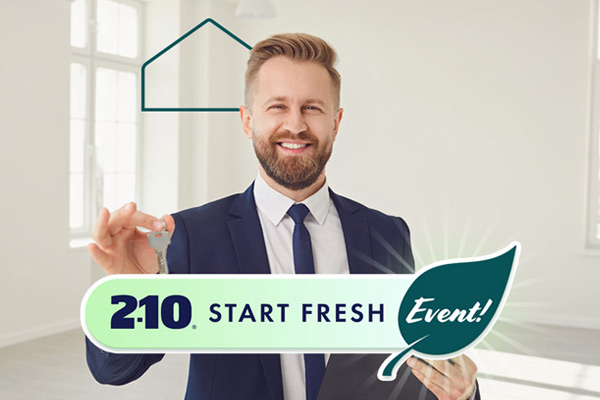 A White male real estate agent smiling and holding keys in his right hand with the words 2-10 Start Fresh Event in a rounded button on the lower half. The word "Event" appears in a leaf.