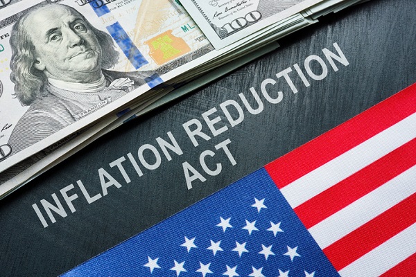USA flag, dollars and inscription inflation reduction act papers.