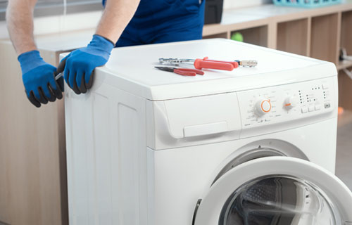 Contractor repairing broken washer