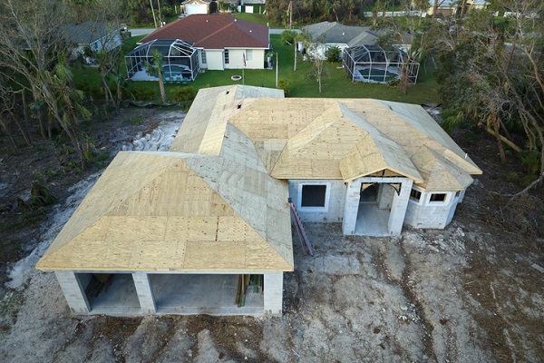 Aerial view of residential private home with wooden roofing structure under construction in Florida quiet rural area. Real estate development concept.