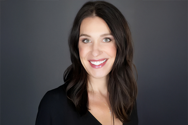 Headshot of Jeanine LaMay Kay. Woman smiling with long dark hair,